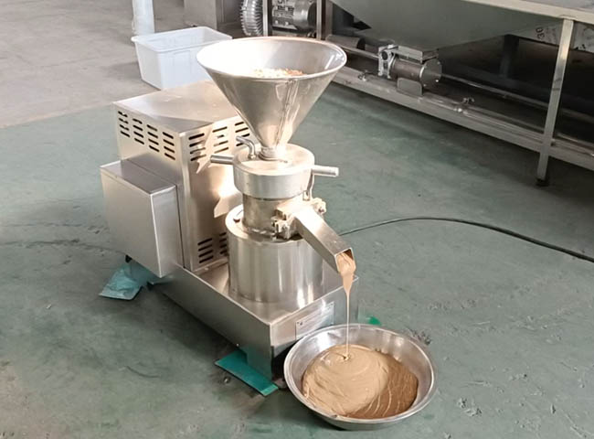 High-capacity commercial peanut butter machine in action.